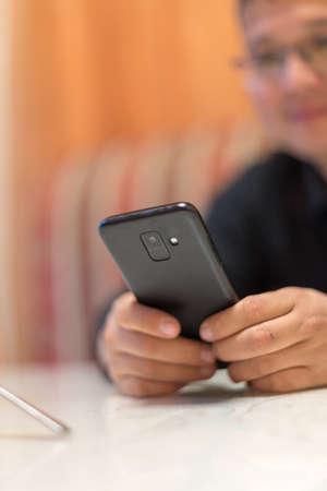 A man sits in a cafe and reads SMSの写真素材