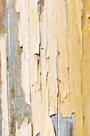 painted old wooden board with peeling paintの写真素材