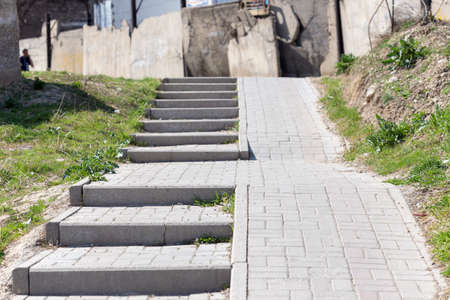 Stone steps on the sidewalk to climb the upper roadの写真素材