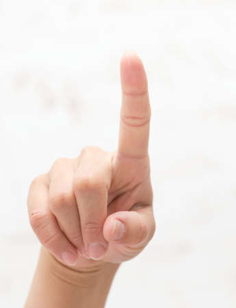 Hand shows number one, isolated backgroundの写真素材