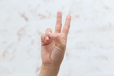 Hand shows number two, isolated backgroundの写真素材