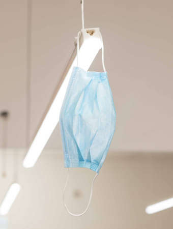 bathroom with white sink, modern black techno style faucet, next to a black plastic bucketの写真素材