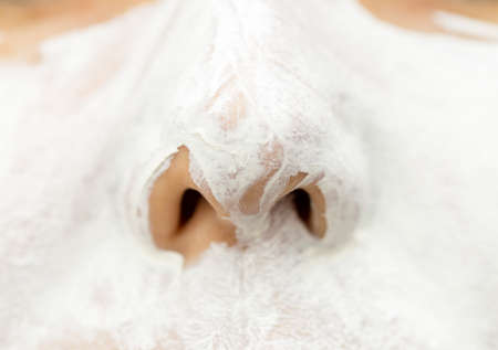 beautiful woman face white cream on white background
