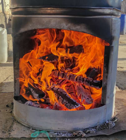 wood, fire is burning, coals in the stove, wood-fired heating conceptの写真素材