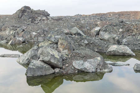 The last snow in the alps. Dirty snow on the rocksの写真素材