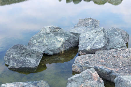 The last snow in the alps. Dirty snow on the rocksの写真素材