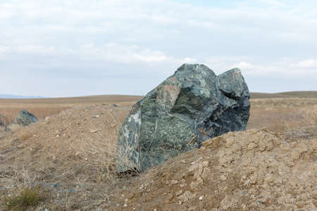 The last snow in the alps. Dirty snow on the rocksの写真素材