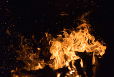 Fire creates endless shapes as it burns, flames and black backgrounds create interesting textures. Flame of Hell. Combustion power.の写真素材
