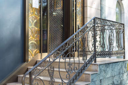 pink artificial flowers on a glass bottle, a bouquet of silk flowers on a white table next to a book and scentの写真素材