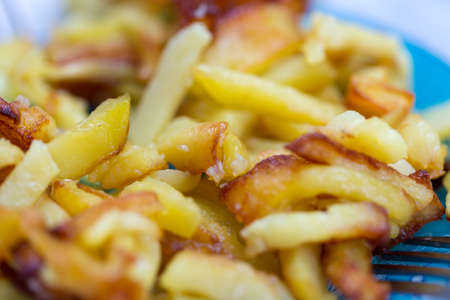 French fries on plate and fork, little leftの写真素材