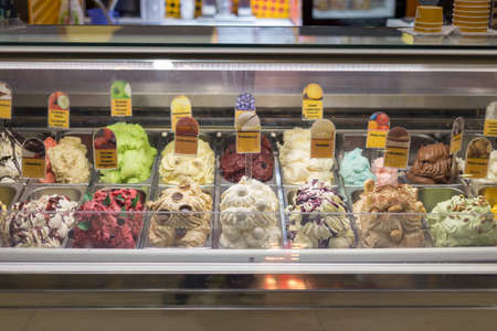 different types of ice cream, frozen desserts in a glass refrigeratorの写真素材