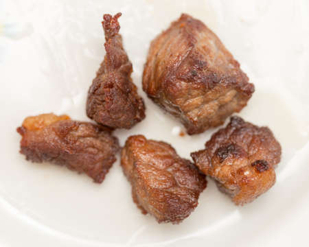 slices of roast beef on a white plate