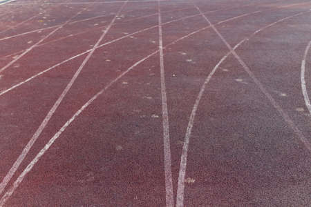 brown running tracks with white markings in the stadiumの写真素材