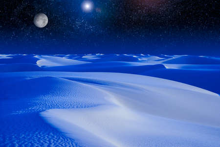 A digital composite of a moon rising over a sand dune の写真素材