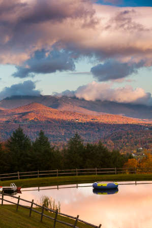 Overlooking a swimming pond with Mt  Mansfield during fall foliage in the background, Stowe, Vermont, USAのeditorial素材