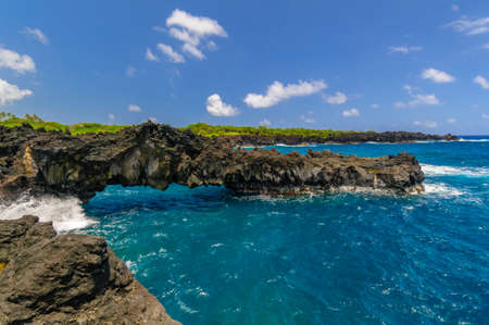 Waves breaking on the rocks on a sunny day during a spectacular ocean view on the Road to Hana, Maui, Hawaii, USAの写真素材