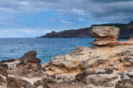 Boulder on a edge of cliff overlooking the Pacific Ocean, Maui, Hawaii, USAの写真素材