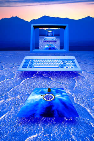 Retro image of an old fashiond omputer and floppy disc floating over blue salt flats の写真素材