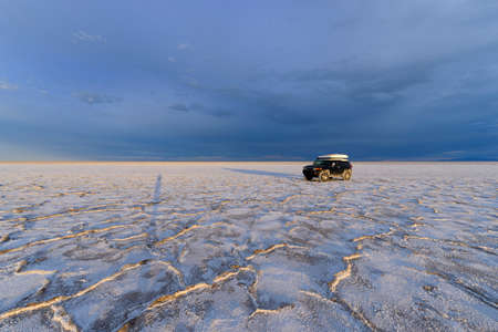 Black 4x4 truck covered in salt at the Bonneville Salt Flats, Utahの写真素材