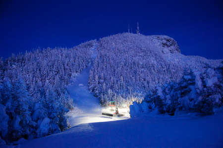 Snowcat grooming trails in the early morning, Stowe, Vermont, USAの写真素材