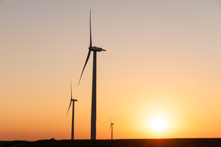Silhouette of large wind turbine farm at sunset, Dexter, Minnesota, USAの写真素材