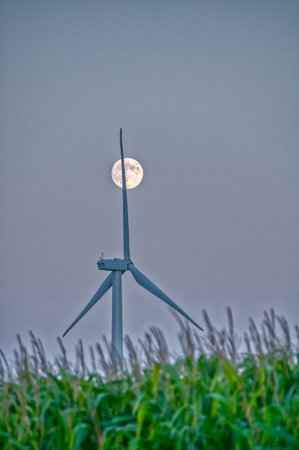 Moonrise over a lone wind turbine in Dexter Minnesota USAの写真素材