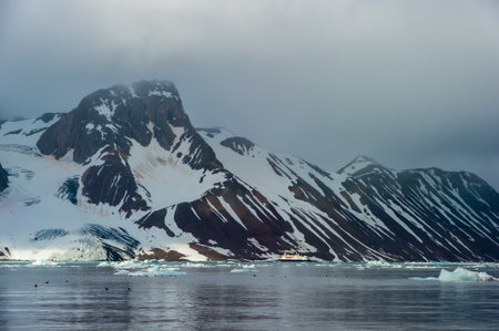 HORNSUND, SVALBARD, NORWAY â€“ JULY 26, 2010:  National Geographic Explorer cruise ship in...
