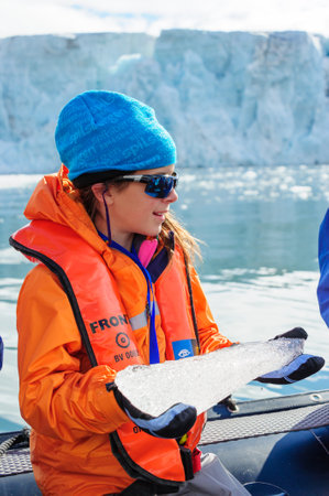 HORNSUND, SVALBARD, NORWAY â€“ JULY 26, 2010: Young girls from the National Geographic Explorer...
