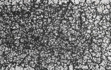 rough cracked surface with a grunge deep effect from a black and white texture - abstract monochrome background wallpaper with a broken peeling paintingの写真素材