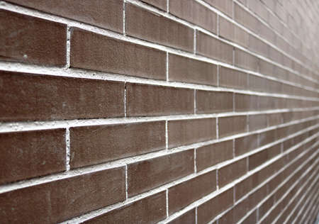 perspective of a big brick wall with dark brown and white color - regular and well aligned bricks...