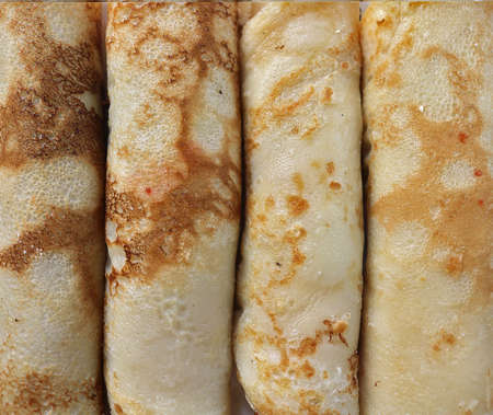 handmade crepes or pancakes baked recipe, closeup rolled up sweet breakfast or dessert textureの写真素材