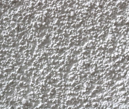Popcorn ceiling texture of a wall in white color - rough surface backgroundの写真素材