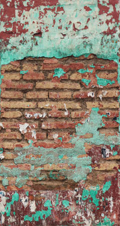 irregular and colorful brick wall turquoise, white and red with dirt and different textures - vertical cyber punk backgroundの写真素材
