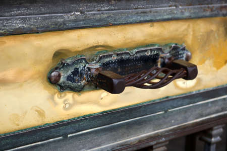 Golden rectangular steam punk rusty surface with a door knob - framed and polished aged blank gold panel backgroundの写真素材