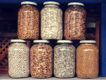 Big glass pots with healthy food, nuts, legumes and seedsの写真素材