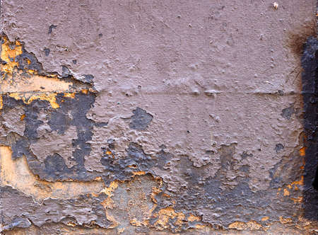 old weathered wall with peeling paint in different gray and yellow layers - rough dirty texture for...