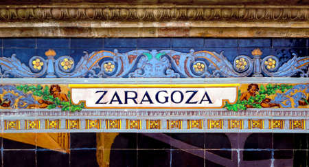 Tile with the name of the Spanish city of Zaragoza on ceramic with a colorful decoration located in Spain Square in Sevilleの写真素材