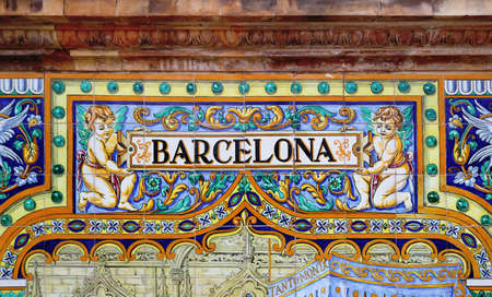 Tile with the name of the Spanish city of Barcelona on ceramic with a colorful decoration located in Spain Square in Sevilleのeditorial素材