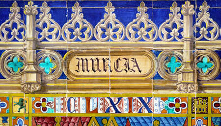 Tile with the name of the Spanish city of Murcia on ceramic with a colorful decoration located in Spain Square in Sevilleのeditorial素材