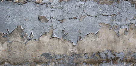 rugh texture background wall with silver peeling paint and chipped over a cement surfaceの写真素材