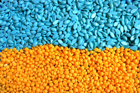 hard wax beans with different sizes, shapes, textures and formats and the colors of the Ukrainian flag in yellow and blueの写真素材