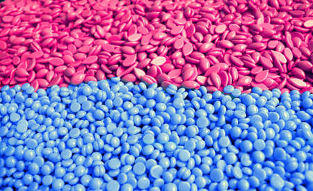 pile of hard wax to remove the hair of the women with different shapes in pink and blue colorsの写真素材