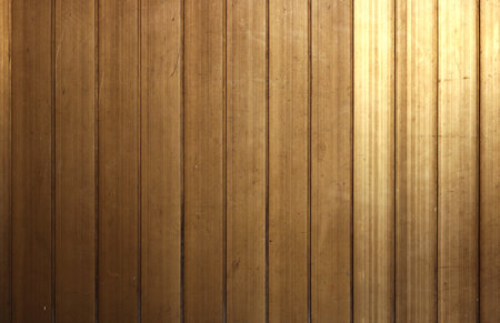 shiny but old golden surface with vertical panels - rich background texture with scratches for old decoration of a wall or doorの写真素材