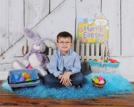 handsome boy sitting in Easter sceneの写真素材