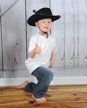 sweet young cowboy being playful in a poseの写真素材