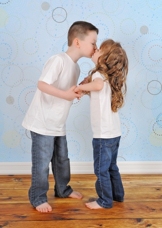  sweet young brother and sister sharing a kissの写真素材