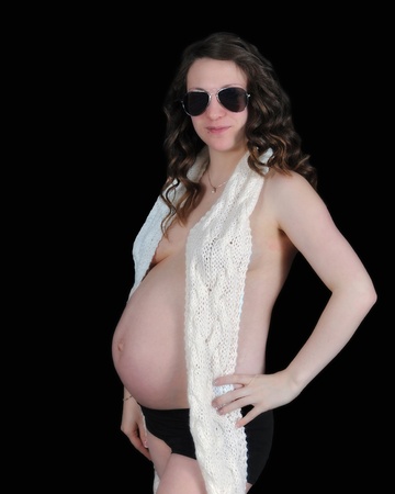 pregnant woman in sunglasses and scarf exposing bare belly. isolated on blackの写真素材