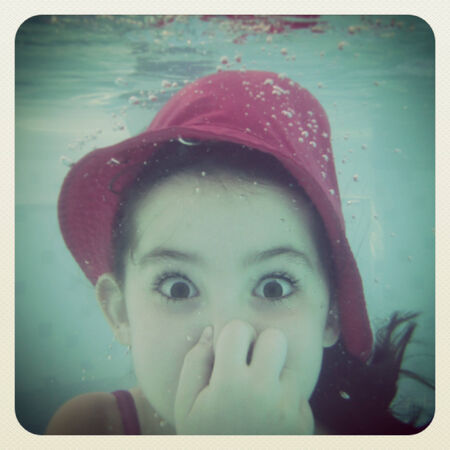 young girl having fun under waterの写真素材