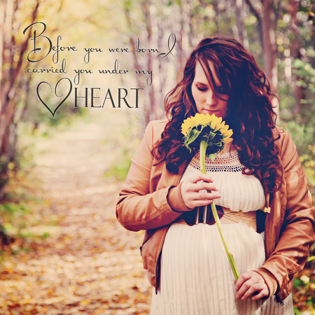 stunning pregnant woman on forest path with quoteの写真素材