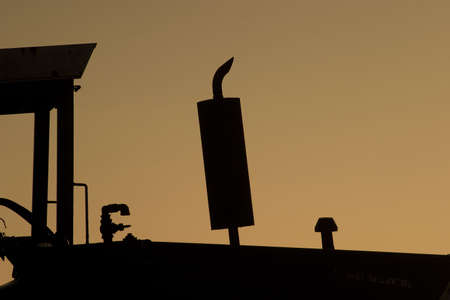 tractor at sunrise silhouette exhaustの写真素材